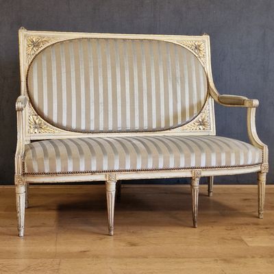 an image of a white couch sitting on top of a hard wood floor
