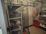 a kitchen with a rack of pans and pans on it