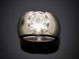 a close up of a ring with a diamond on a black surface