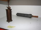 a small metal object sitting on a shelf next to a bottle