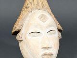 a close up of a clay head with a hat on it