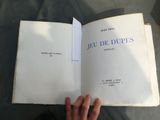 a person holding a book open on a table