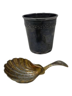 a black cup and a gold spoon next to each other