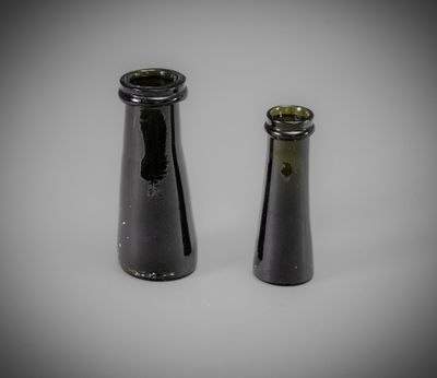 two black vases sitting next to each other on a table
