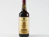 a bottle of wine sitting on top of a white table