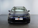 the front of a blue vw golf parked in a room