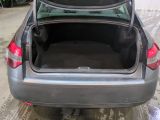 a car with its trunk open in a garage