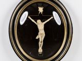 a black and gold clock with a crucifix on it