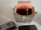 two old cameras and a small box on a table