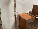 a floor lamp that is next to a wooden table