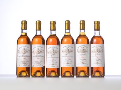 four bottles of wine are lined up on a table