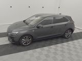 the grey car is parked in the garage on the checkered floor