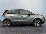 the silver car is parked on the concrete floor in the room