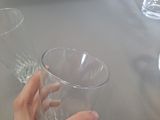 a person holding a glass of wine on a table