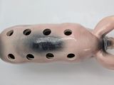 a ceramic pig figurine with holes in it