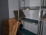 a bunk bed in a small room with a chair