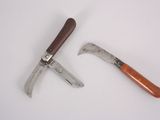 two different types of garden tools on a white surface