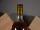 a bottle of wine sitting on a table with wooden blocks in the background