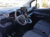 the interior of a small car with a steering wheel and dashboard