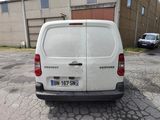 a white van that is parked in a parking lot
