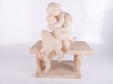 statue of a woman sitting on a bench holding a baby