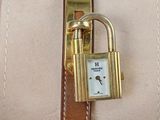 a watch with a padlock attached to it ' s wrist