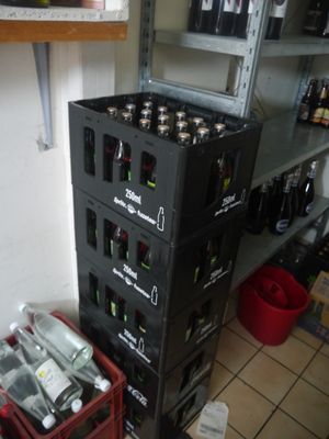 bottles of beer are stacked on top of each other in a room