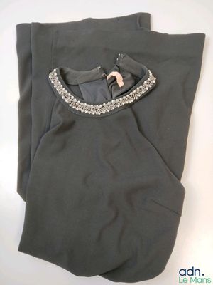 the top of a pair of gray pants with a beaded collar