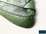 a green purse that is sitting on a table