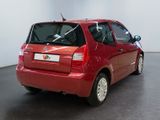 a red car that is parked in a room