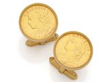 a pair of gold cufflinks with a coin in the middle