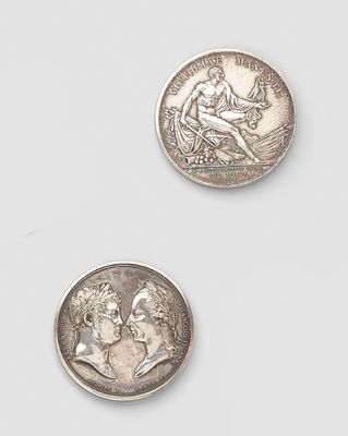 two silver coins, one with the head of a man and one with a woman