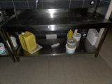 a black counter with two buckets and a yellow container