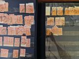 a refrigerator with many stamps on it next to a window