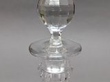 a clear glass candle holder with a crystal ball on top