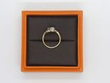 a gold ring with a diamond in it in a box
