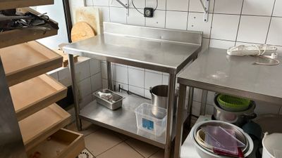 a kitchen with a stainless steel counter and shelves