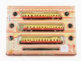 three toy trains in a box on a white surface