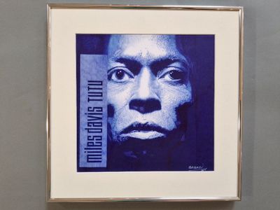 blue and white photograph of a man ' s face in a picture frame
