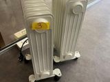 two white radiators that are sitting on the floor