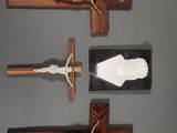 three wooden crucifixs are displayed on a gray surface