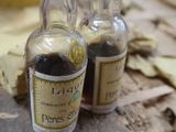 deux petites bouteilles de liquide posées sur une table en bois