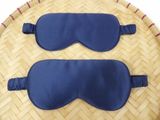 two blue eye masks on a bamboo tray on a table
