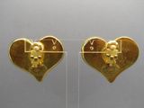 pair of gold heart shaped earrings with a man and a woman on them