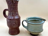 two vases sitting next to each other on a table