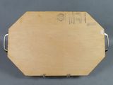 an image of a wooden cutting board with a handle on a gray surface