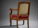 an antique wooden chair with red velvet upholstered seat