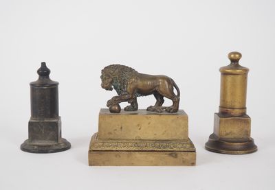 two bronze figurines of a lion and a lion on a pedestal