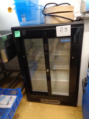 une photo d'un réfrigérateur dans un magasin, sur lequel est apposée une étiquette de prix