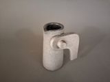 a white vase with an elephant shaped handle on a table